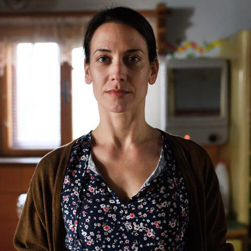 Portrait of mature woman indoors at home